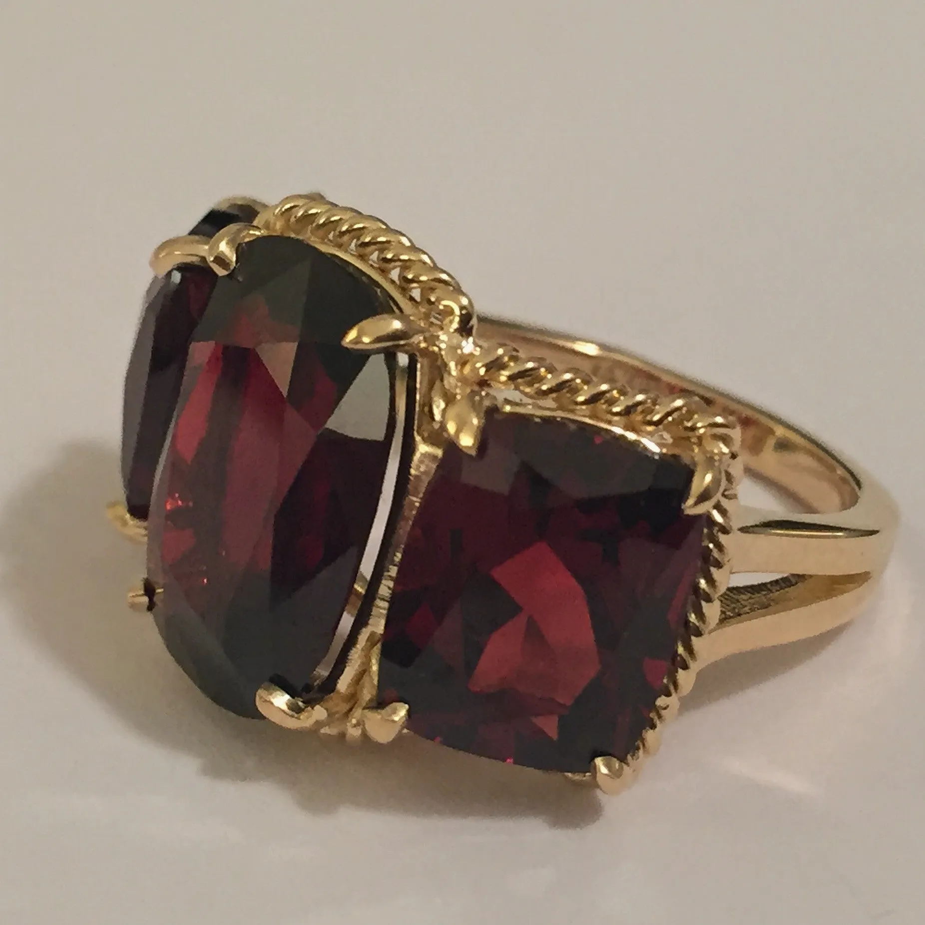 Elegant Three Stone Garnet Ring with Gold Rope Twist Border
